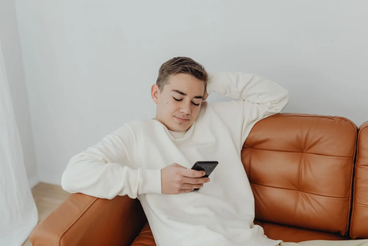 A student using a phone during a break at home